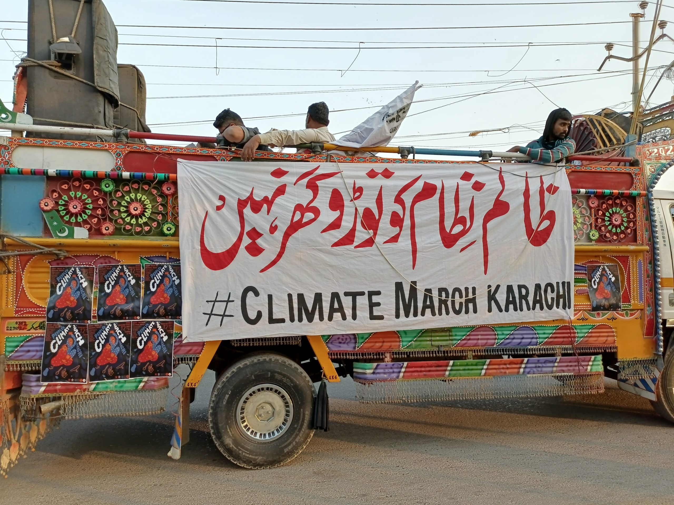 A truck carrying the stage of march leaders flaunts the banner protesting houses' demolitions